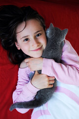 Happy little girl with kitten