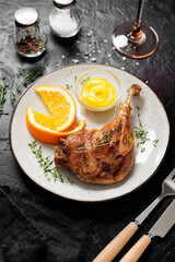 Duck leg confit served with potato chips and mustard sauce .Traditional french cuisine.