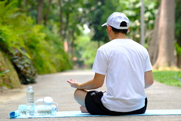 Man doing yoga exercises in the garden and health care concept