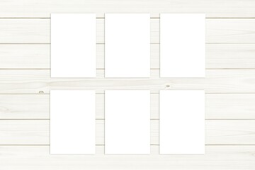 Set of six A5 size cards or posters mockup for design presentation on white wooden background.