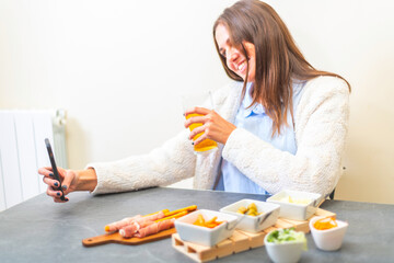 Young person having an online aperitif beers in video call