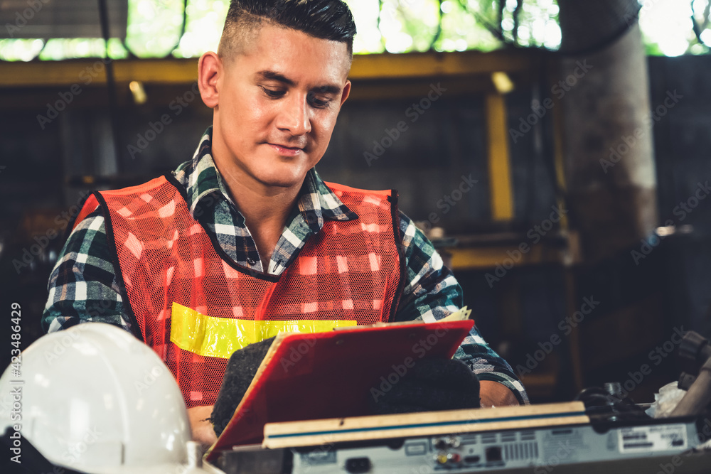 Poster manufacturing worker working with clipboard to do job procedure checklist . factory production line 