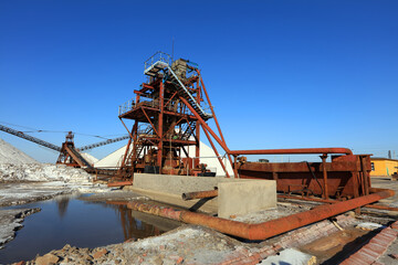 Fototapeta na wymiar Salt production. machinery for the treatment of the salt, The equipment and salt stock of a salt plant