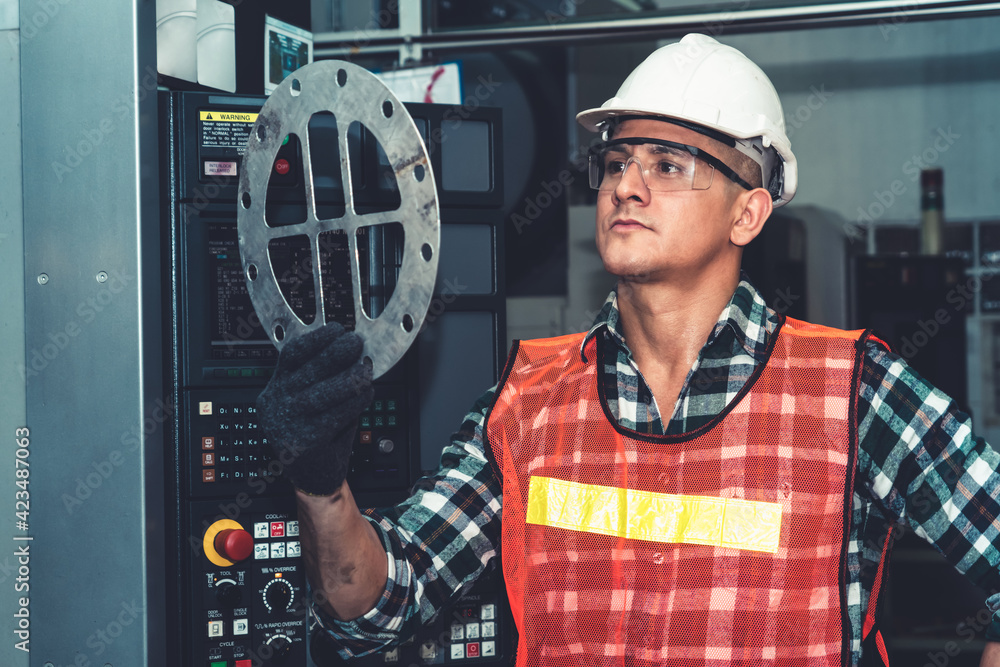 Poster smart factory job worker looking at machine part in manufacturing workshop . industry and engineerin