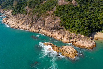 Top down view of the ocean wave crash on the island cliff