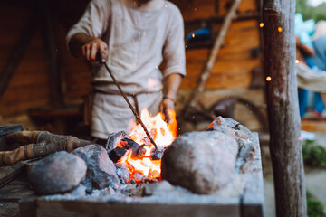 Fire crackling in blacksmith workshop of forging metal. Anonymouse craft smith create objects from...