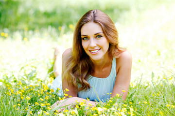 Woman in blue dress lying on grass