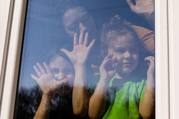 the children stay near the window and enjoy the weather