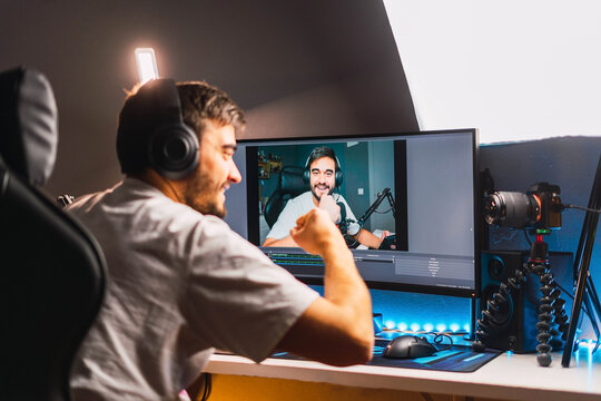 Young gamer playing video games online while broadcasting on social media - Working live streaming on internet platforms	