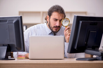 Young male employee in multitasking concept
