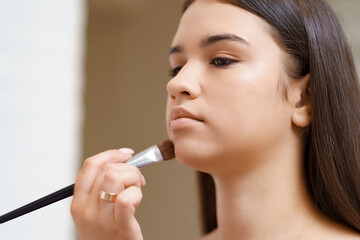 Professional makeup artist working with client in dressing room