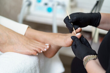 Specialist in beauty salon making french pedicure for female client. Relaxing at beauty salon,...