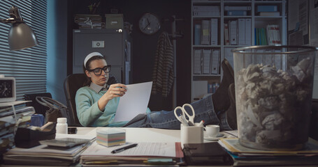 Frustrated woman working in the office at night