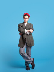 A young woman in a men's suit, gender neutral style.