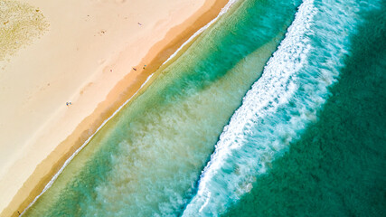 Surf on a sunny beach. Coromandel, New Zealand.