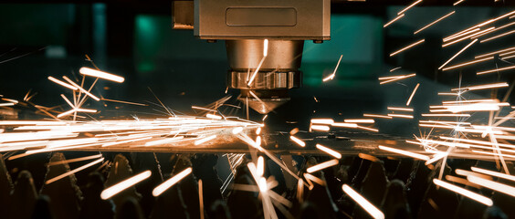 The laser cuts metal. CNC machine. Modern industrial technologies. Close-up of the nozzle. Sparks...