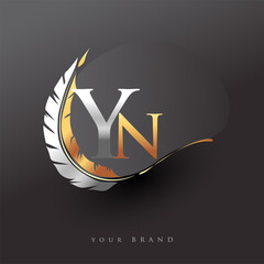 Initial letter YN logo with Feather Gold And Silver Color, Simple and Clean Design For Company Name. Vector Logo for Business and Company. - obrazy, fototapety, plakaty