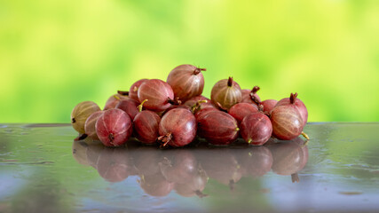 Ripe gooseberries on a table with a wet surface