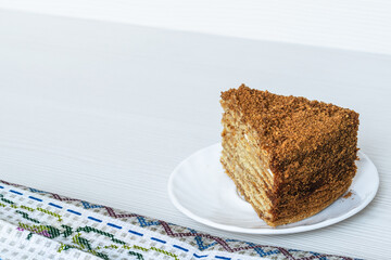 Part of the cake close-up on a light background. Place for an inscription.