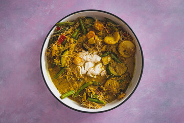 vegan yellow curry with mixed vegetables tofu and vermicelli noodles, healthy plant-based food