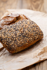 Gold rustic crusty loaves of bread and buns on wooden background. Still life captured from above top view, flat lay.