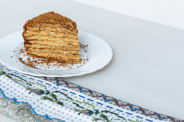 A slice of honey cake on a white plate.