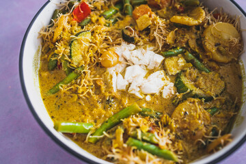 vegan yellow curry with mixed vegetables tofu and vermicelli noodles, healthy plant-based food