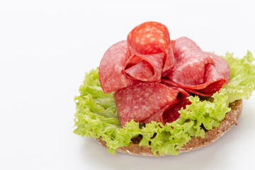 Sandwich with salami sausage on white background.