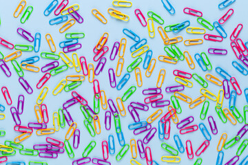 Paper color clip notebook on blue background. Flat lay.