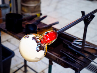 Manual art work in glass blower factory. Glassworks design
