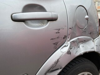 Visible dent on the side of a car due to an accident