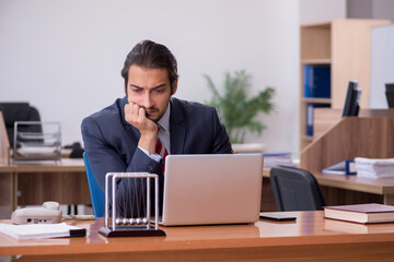 Young man businessman employee sitting in the office