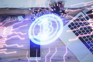Double exposure of blockchain theme hologram over table with phone. Top view. Crypto technology...