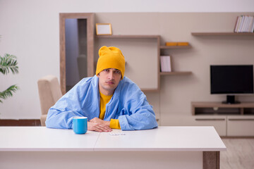 Young man suffering at home