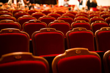 red armchairs in classic style in an empty theater hall