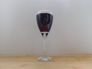 Glass of wine on wooden table. Top view.