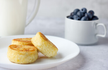 Cottage cheese pancakes with fresh blueberries and milk. Homemade food. Healthy Breakfast.