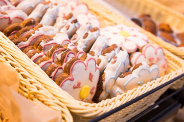 glazed flower shaped pastries on a bakery counter