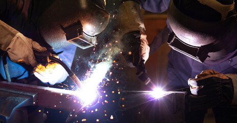 Welder is welding the steel in the factory. Weld the steel in dark.