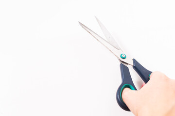 scissors in hand on a white background