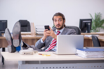 Fototapeta premium Young male employee working in the office