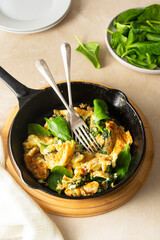 Spinach and cheese omelet, scrumblet eggs, healthy breakfast food in frying pan