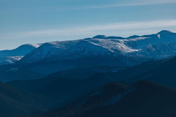 Fototapeta na wymiar Carpathian mountains, winter, snow-capped peaks, viaduct, horse