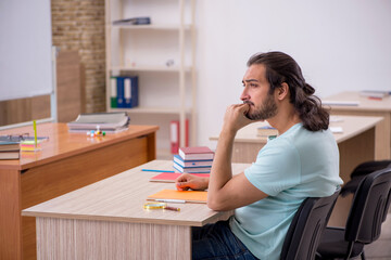 Young male student in the classroom during pandemic