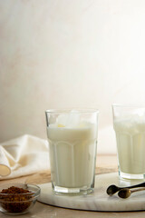 Glass of milk, iced dalgona coffee, step by step recipe. Summer whipped coffee cold drink with vegan milk