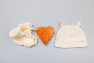 Baby concept. knitted things for the baby handmade on grey  background. Place for text. View from...