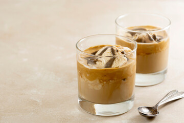 Affogato with Ice Cream, coffee glass with whipped cream and syrop, bright background