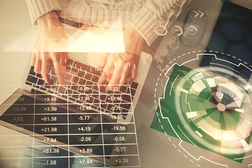 Double exposure of woman hands working on computer and forex chart hologram drawing. Top View. Financial analysis concept.