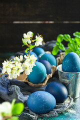 easter eggs season trend painted blue colour, easter treat festive table rustic meal top view copy space food background 