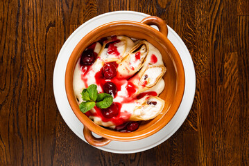 crepes with cottage cheese and berry sauce, top view